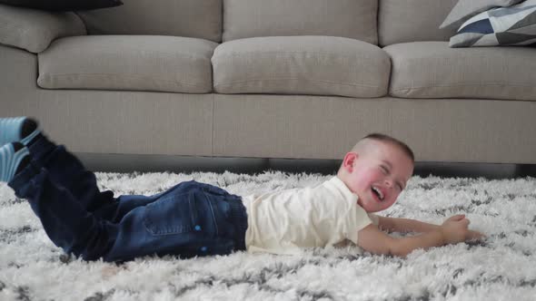 Little Boy Rolling on the Floor While Throwing a Tantrum