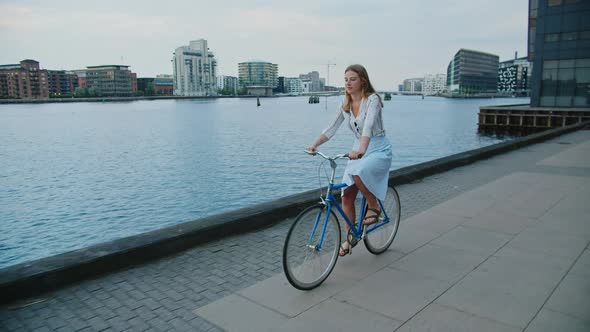 Blond Woman Starting To Ride Bicycle