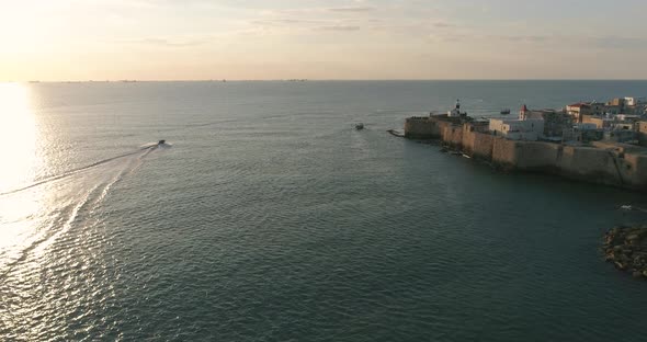 Aerial view of a motor boat sailing near Acre old town, Israel.