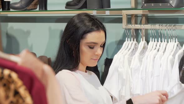 Attractive Young Woman Enjoying Shopping for New Clothes