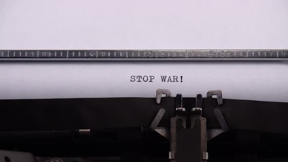 Typing phrase "STOP WAR !" on retro typewriter.