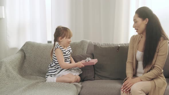 Happy Mother's Day Little Daughter Congratulates Mom and Gives Her a Gift