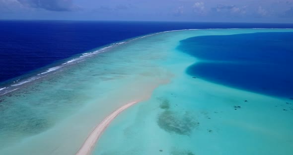 Luxury birds eye clean view of a sunshine white sandy paradise beach and aqua blue ocean background 