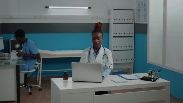 Portrait of Healthcare Specialist with White Coat in Cabinet