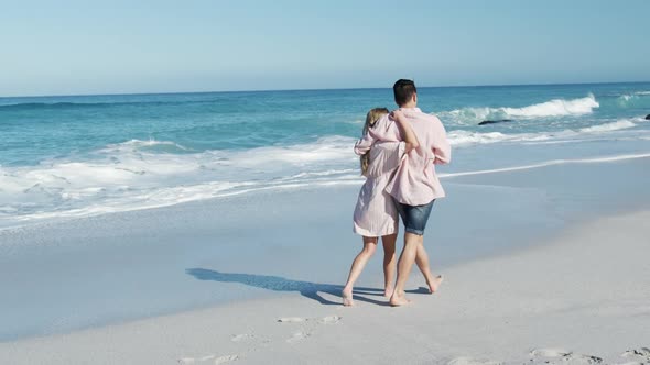 Couple in love enjoying free time on the beach together