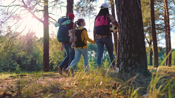 Happy Family Hiking Through a Forest