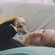 Young blonde woman laying on couch playing with her hair - VideoHive Item for Sale