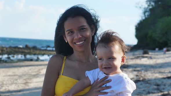 Portrait of a Young Asian Mother and Her Little Baby Smiling to the Camera