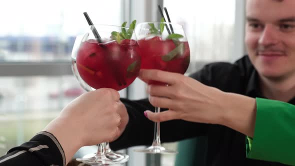 Friends Raising Glasses in a Cafe