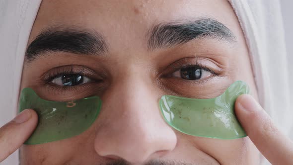 Details Male Face Indian Arabian Man with Bath Towel on Head Uses Hydrogel Green Eyepatches Facial