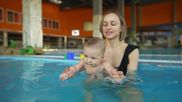 Mother Teaches Her Baby to Swim in a Closed Public Pool
