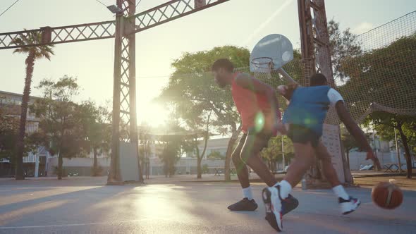 Cinematic footage of a street basketball game outdoor.