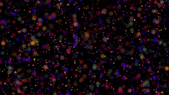Colored festive confetti swirl and flicker on a dark background