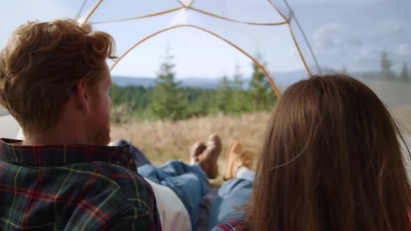 Young Couple Relaxing in Camping Tent