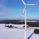 Bottom up aerial view of a wind farm. Rotating wind power plants in a winter landscape. - VideoHive Item for Sale