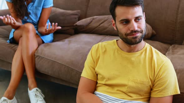 Couple arguing with each other in living room