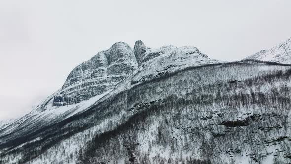 Snow Peak Mountain Hike In Manndalen, Lyngenfjord During Winter In Northern Norway. Aerial Shot