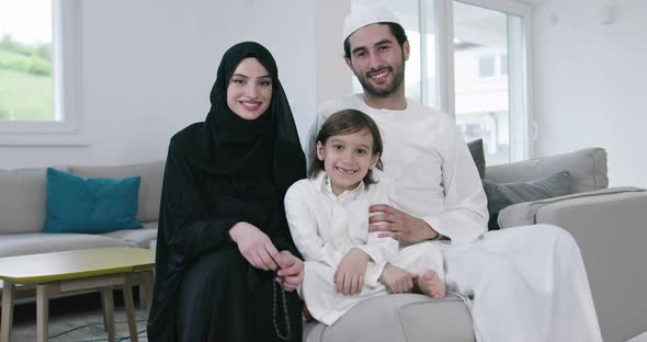 Traditional Muslim Family Parents with Children Together on the Sofa