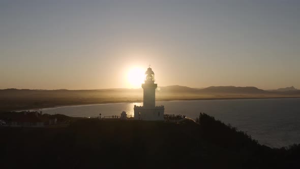 Aerial view of lighthouse at sunset.