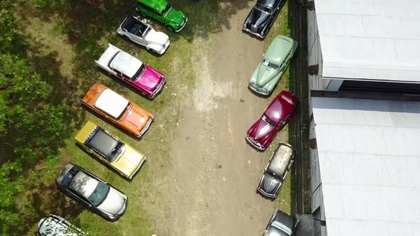 Colorful Collection of Antique Vintage Classic Cars Overhead Tilt Up Drone Shot