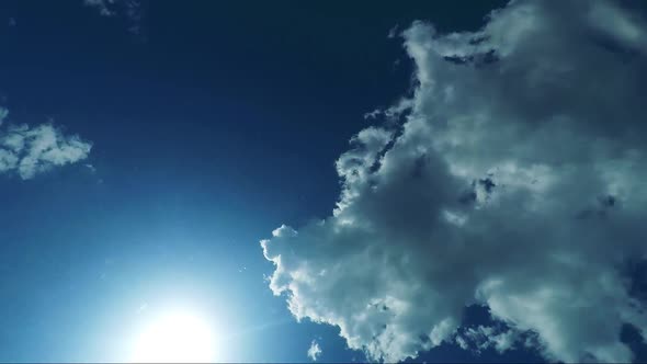 Detail of the Calm Water Surface with Sun and Clouds in the Sky - Shot From the Bottom of the Pool