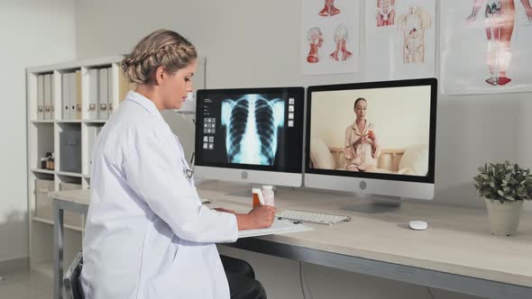 Female Doctor Consulting Patient via Online Video Call