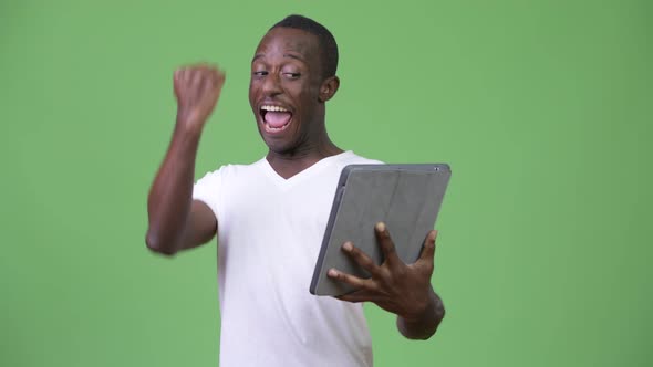 Young Happy African Man Using Digital Tablet