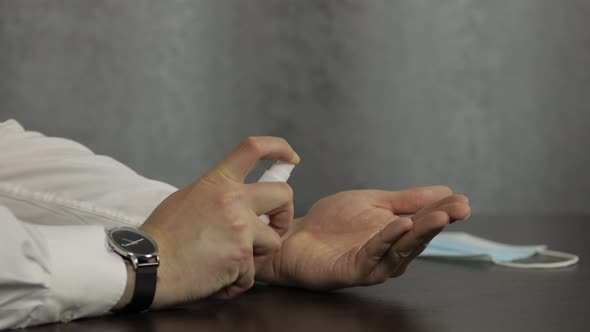 Man Using Bottle of Liquid Alcohol Spray Sanitizer with Hands. Coronavirus