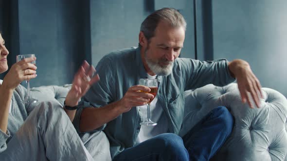 Aged Couple Drinking Wine