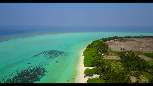 Aerial above landscape of luxury seashore beach vacation by blue green ocean with white sand backgro