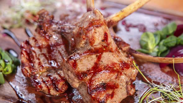 Bbq lamb meat cooked on grill pan for dinner in restaurant and served on plate