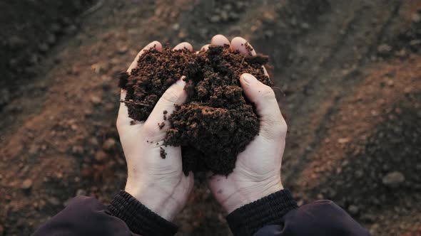 Farmer Holding Soil in Hands Close-up