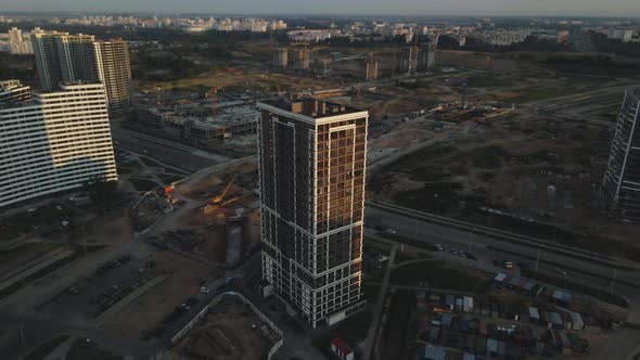 City block construction site. Multi-storey buildings. City landscape at sunrise. Aerial photography.