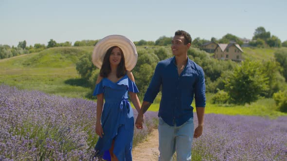 Joyful Multiracial Couple Walk in Lavender Field