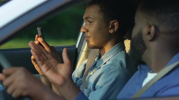 Afro-American Man Irritated With Son Scrolling Smartphone, Gadget Addiction