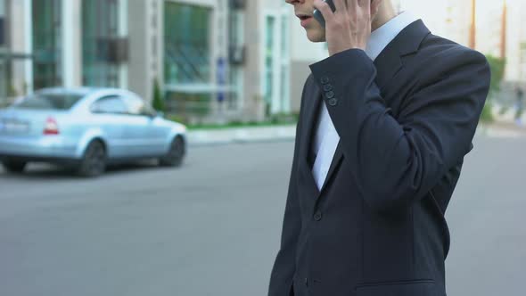 Businessman Talking on Cellphone, Getting Insider Information, Arranging Meeting