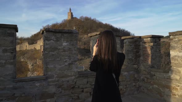 Brunette Girl with Black Jacket Enjoying Sunny Autumn Day in Old Medieval Stronghold Called