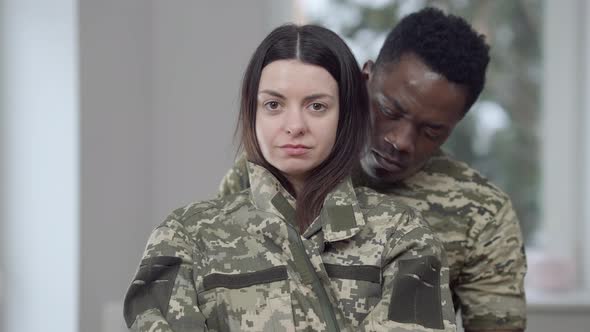 Young Loving Interracial Couple Posing at Home Before Husband Leaving for Military Service