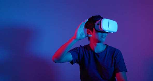 Man Looking Though the VR Device with Red and Blue Light