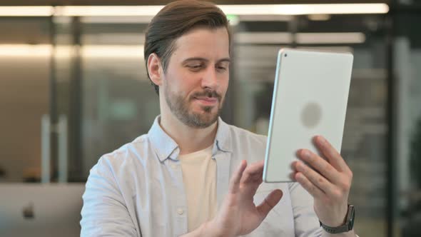 Portrait of Man Celebrating Success on Tablet