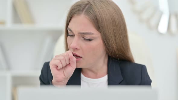 Close Up of Young Businesswoman Coughing at Work