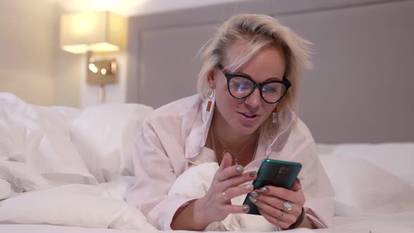 Woman Is Using Social Nets in Smartphone in Bed Before Sleep Internet Addiction