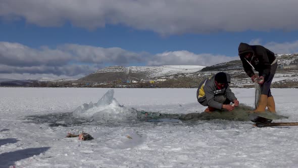 Men Fishing in The İcy Lake.