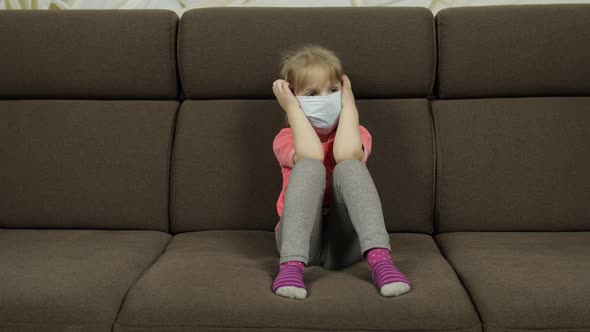 Concept of Sick Little Girl Wearing a Medical Mask. Quarantine. Coronavirus