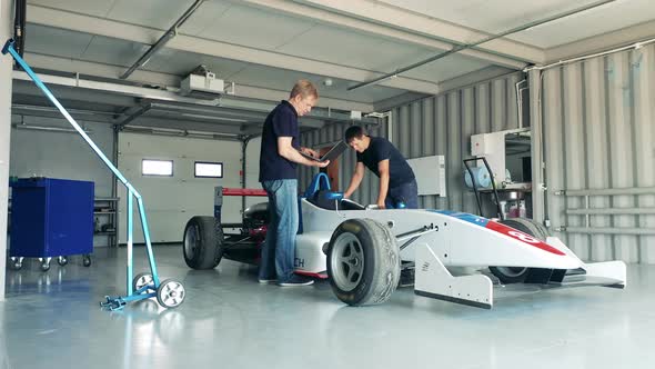 Racing Car is Getting Checked By Garage Specialists