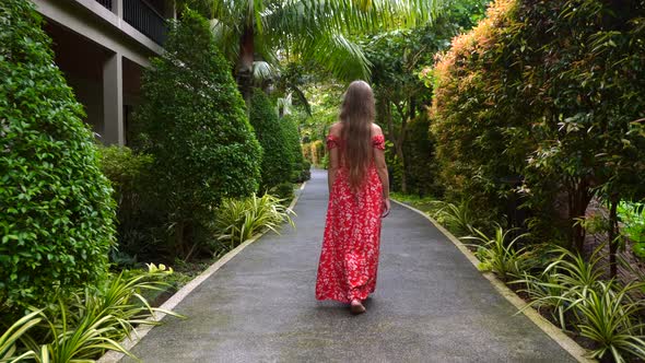 Slow Motion of Travel Woman Walking Barefoot on Path in Modern Tropical Resort