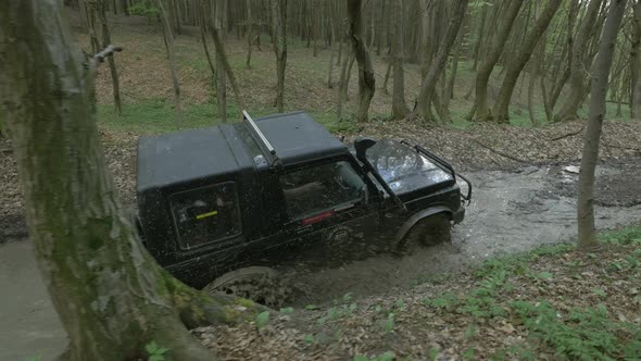 Truck driving in mud in a forest