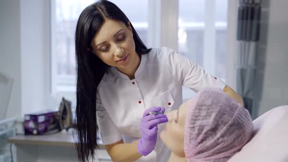 A Female Cosmetologist Makes Beauty Injections For a Client