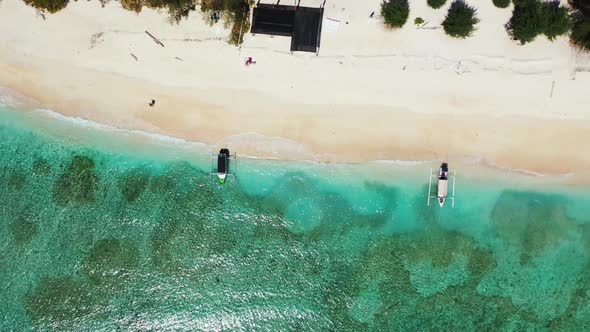 Aerial above landscape of idyllic sea view beach journey by aqua blue ocean and bright sandy backgro