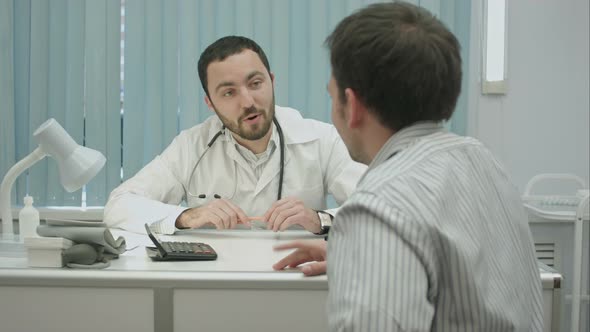 Male Bearded Doctor in Clinic Offer Good Price for Treatment.